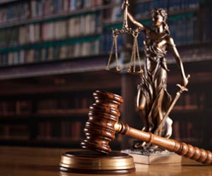 The Statue Of Justice and Gavel On a Table The Statue Of Justice and Gavel On a Table