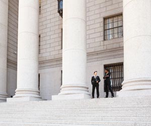 Man and Woman Converse on the Steps of a Legal or Municipal Building Man and Woman Converse on the Steps of a Legal or Municipal Building